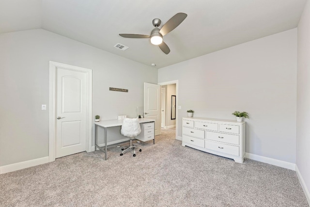 carpeted home office featuring lofted ceiling and ceiling fan