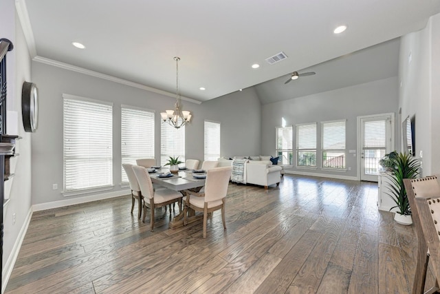 dining area with vaulted ceiling, ornamental molding, hardwood / wood-style flooring, and a notable chandelier