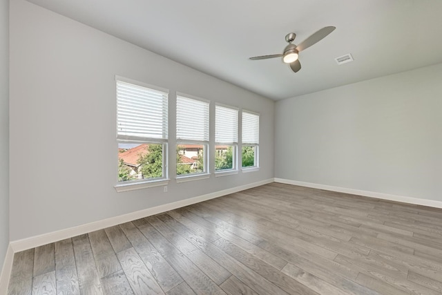 empty room with ceiling fan and light wood-type flooring