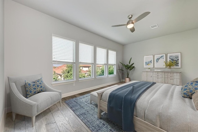 bedroom with wood-type flooring and ceiling fan