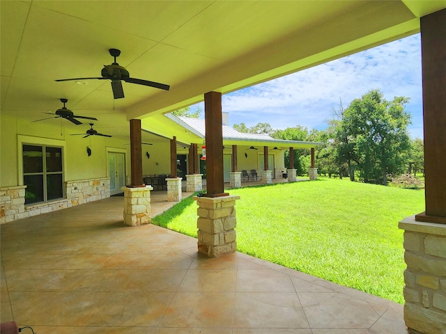 view of yard with ceiling fan and a patio area