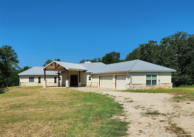 single story home with a garage and a front yard