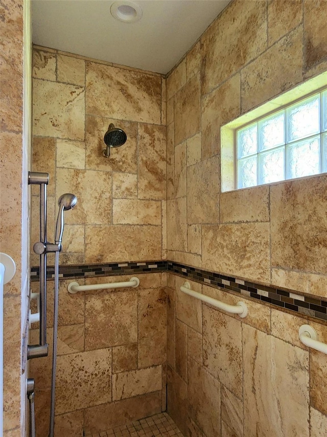 bathroom with tiled shower