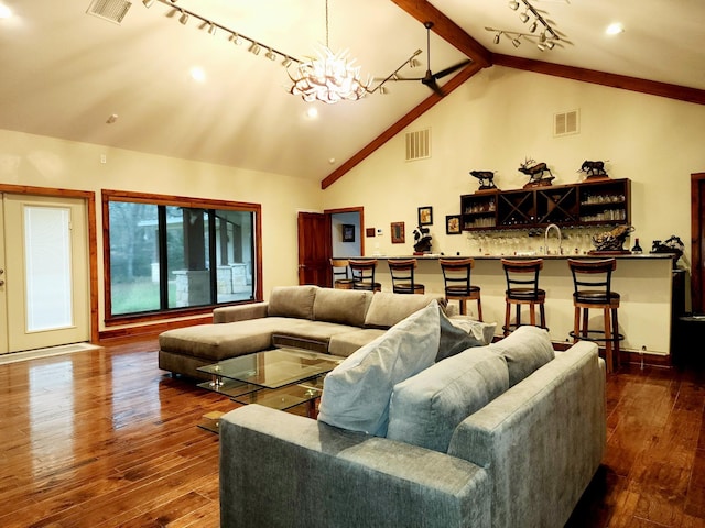 living room with indoor wet bar, vaulted ceiling with beams, dark hardwood / wood-style flooring, and a chandelier