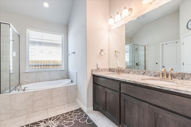 bathroom featuring lofted ceiling, a stall shower, and a sink