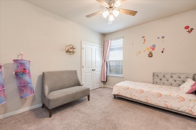 carpeted bedroom featuring ceiling fan and a closet