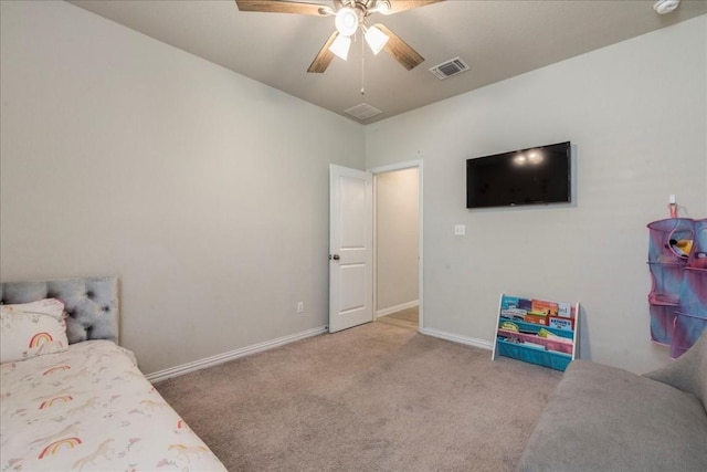 carpeted bedroom with a ceiling fan, visible vents, and baseboards