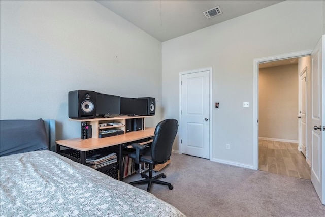 carpeted bedroom with lofted ceiling