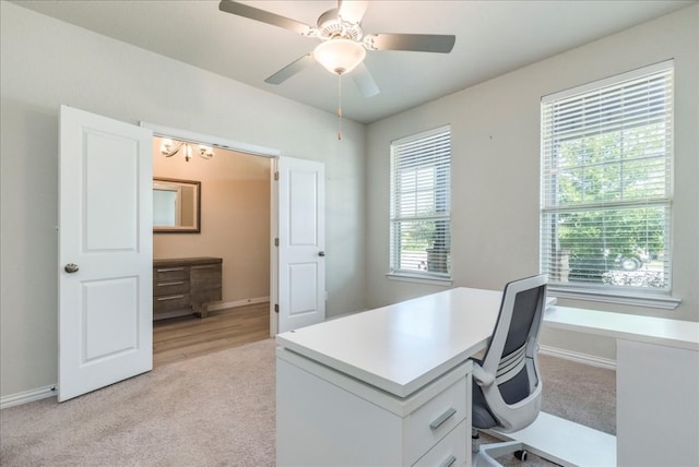 home office with light colored carpet, plenty of natural light, and ceiling fan