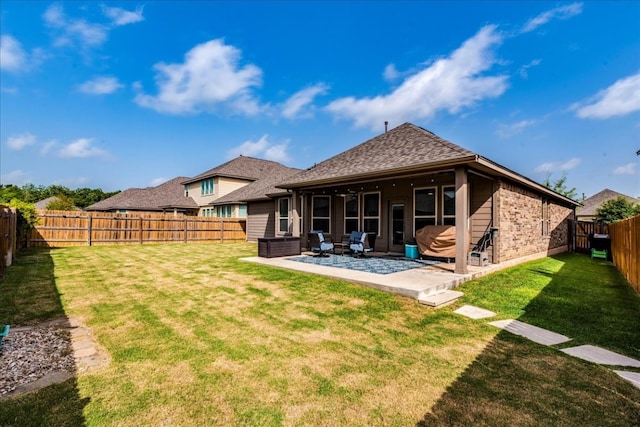 back of house featuring a patio and a lawn