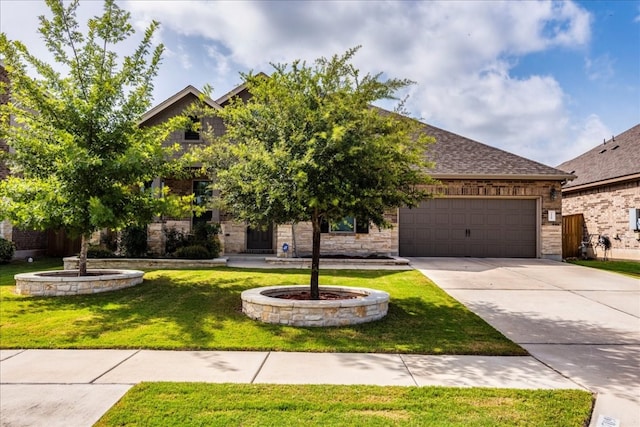 view of front of house featuring a front yard and a garage