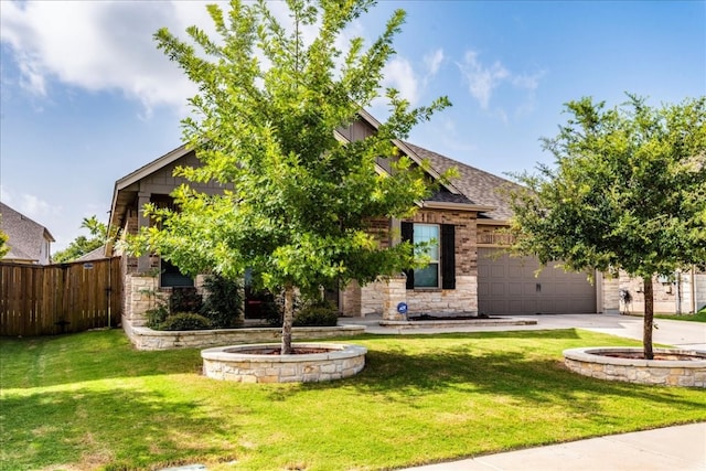 obstructed view of property with a garage, fence, concrete driveway, stone siding, and a front yard