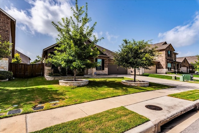 obstructed view of property featuring an attached garage, fence, concrete driveway, and a front yard