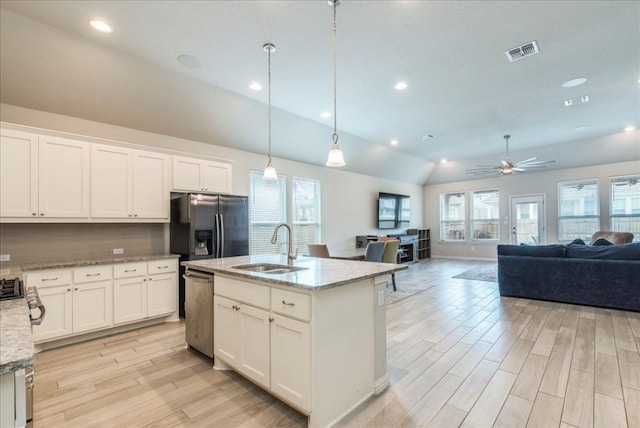 kitchen featuring pendant lighting, a healthy amount of sunlight, stainless steel appliances, and vaulted ceiling