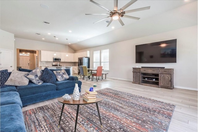 living area with light wood-style floors, lofted ceiling, visible vents, and recessed lighting