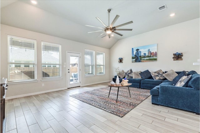 living area with lofted ceiling, visible vents, ceiling fan, wood finished floors, and baseboards