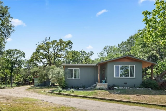 2108 River Hills Rd, Austin, TX 78733 - view of front facade with stucco siding, driveway, and a front lawn