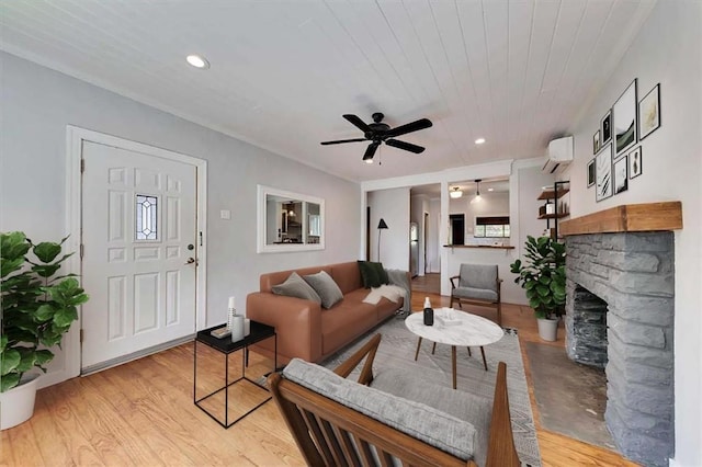 2108 River Hills Rd, Austin, TX 78733 - living room with a wall mounted AC, ceiling fan, light wood-type flooring, a fireplace, and recessed lighting