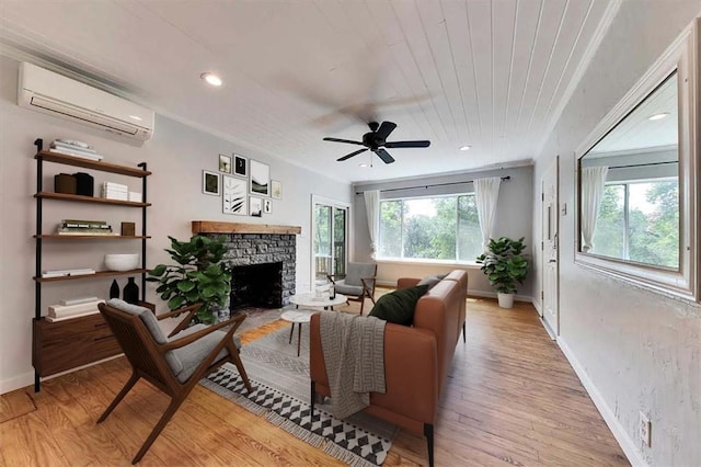 2108 River Hills Rd, Austin, TX 78733 - living room with a wall mounted air conditioner, a stone fireplace, light wood finished floors, baseboards, and a ceiling fan