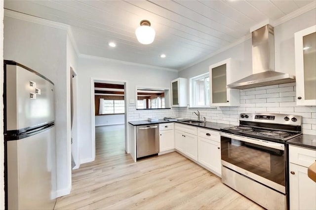 2108 River Hills Rd, Austin, TX 78733 - kitchen featuring stainless steel appliances, wall chimney exhaust hood, crown molding, dark countertops, and decorative backsplash
