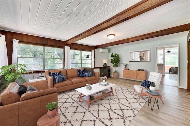 2108 River Hills Rd, Austin, TX 78733 - living room featuring an AC wall unit, wood finished floors, and beamed ceiling
