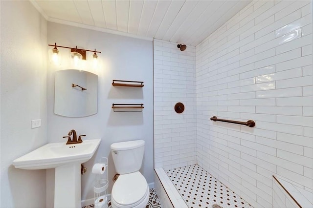 2108 River Hills Rd, Austin, TX 78733 - bathroom featuring toilet, tiled shower, and ornamental molding