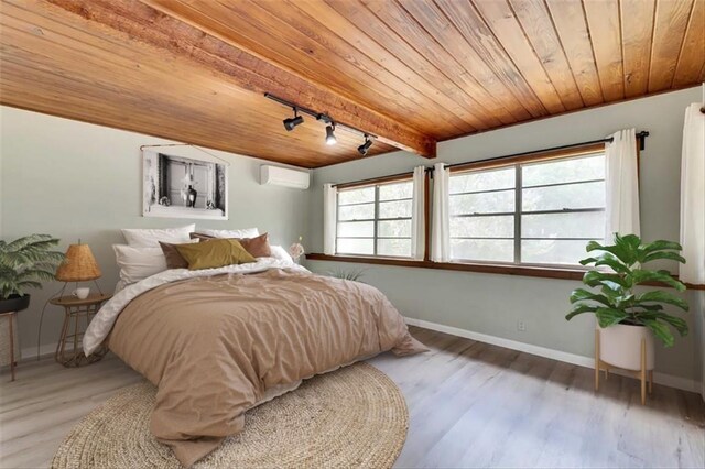 2108 River Hills Rd, Austin, TX 78733 - bedroom featuring a wall mounted AC, wood ceiling, baseboards, light wood-style floors, and rail lighting