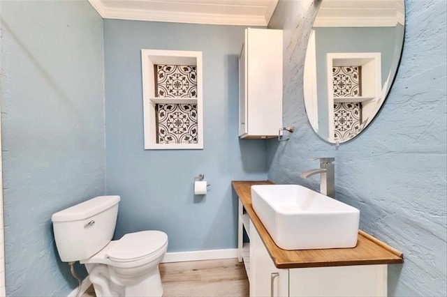 2108 River Hills Rd, Austin, TX 78733 - half bath with toilet, vanity, crown molding, wood finished floors, and baseboards