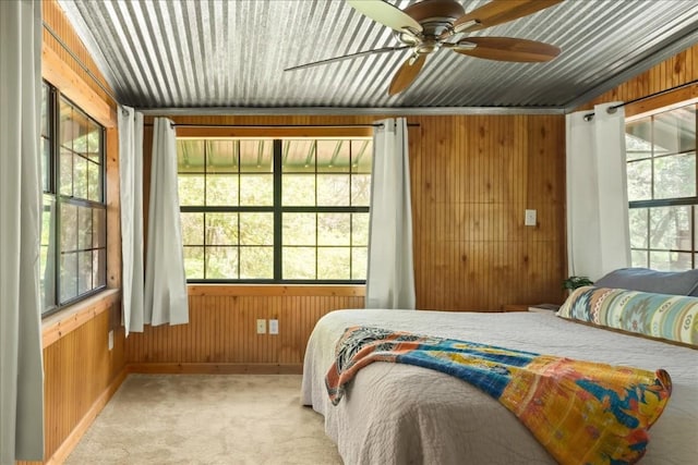 2108 River Hills Rd, Austin, TX 78733 - bedroom with wooden walls, multiple windows, light colored carpet, baseboards, and a ceiling fan