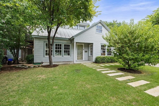 1202 E 30th St, Austin, TX 78722 - view of front of house with a front yard, a standing seam roof, and metal roof