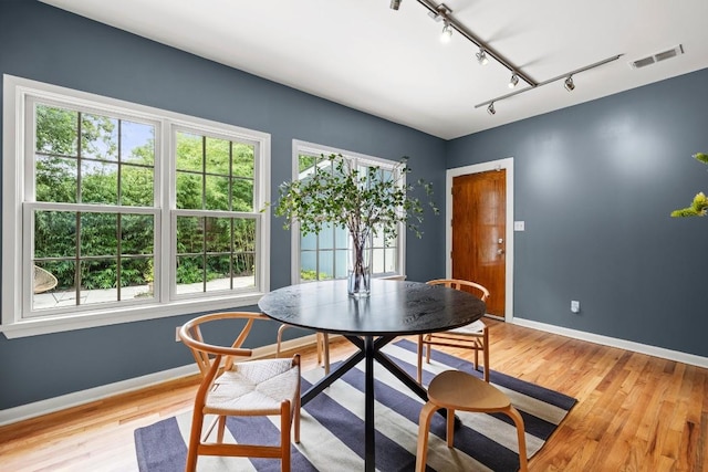 1202 E 30th St, Austin, TX 78722 - dining area featuring visible vents, baseboards, and light wood-style flooring