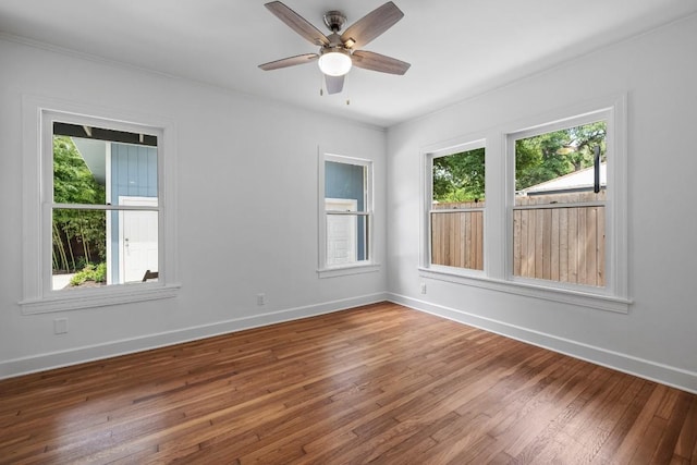 1202 E 30th St, Austin, TX 78722 - empty room featuring hardwood / wood-style floors, a healthy amount of sunlight, and baseboards