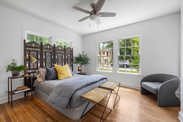1202 E 30th St, Austin, TX 78722 - bedroom with a ceiling fan, wood finished floors, and baseboards