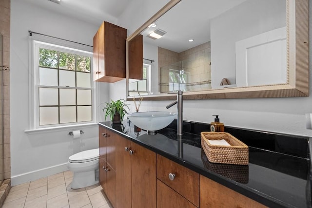 1202 E 30th St, Austin, TX 78722 - full bath featuring vanity, baseboards, tile patterned flooring, a shower stall, and toilet