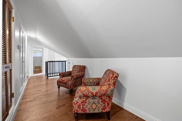 1202 E 30th St, Austin, TX 78722 - living area with baseboards, lofted ceiling, and wood finished floors