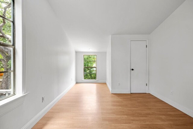 1202 E 30th St, Austin, TX 78722 - spare room with baseboards and light wood-type flooring
