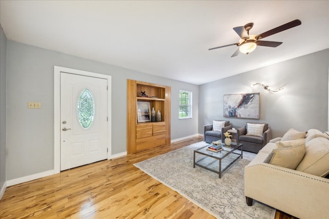 living room with light hardwood / wood-style floors and ceiling fan