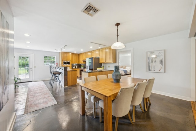 dining area featuring track lighting