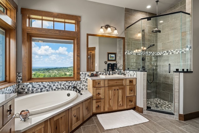 bathroom featuring separate shower and tub, tile patterned floors, and vanity