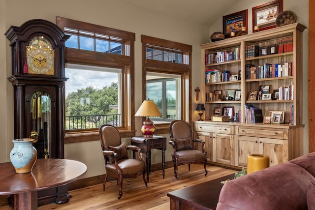 sitting room featuring lofted ceiling and light wood-type flooring