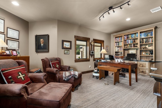 home office featuring light carpet and rail lighting