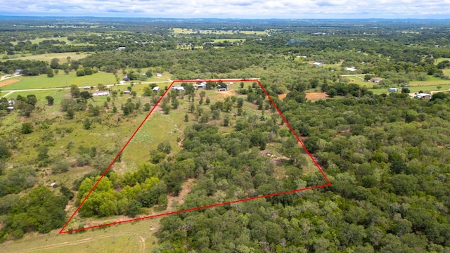 aerial view featuring a wooded view