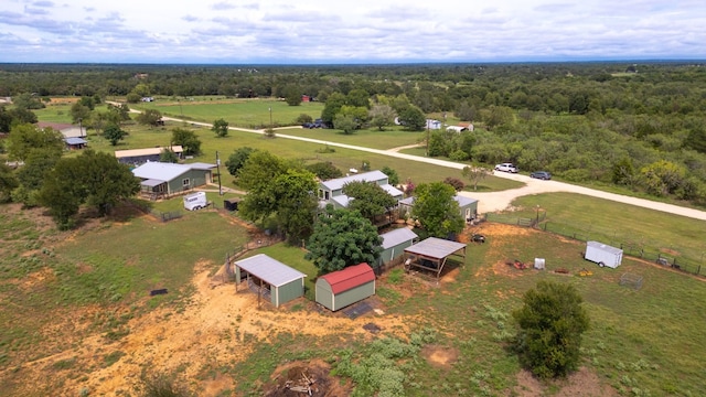 drone / aerial view featuring a rural view and a view of trees