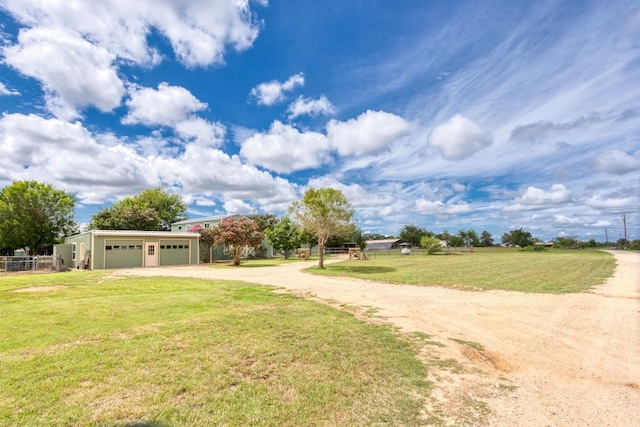 exterior space featuring a garage and dirt driveway