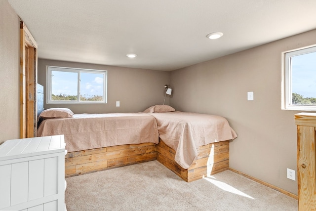 carpeted bedroom featuring multiple windows