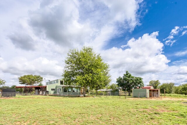 view of yard featuring a rural view and an outdoor structure