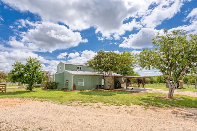 239 Dale Ranch Rd, Dale, TX 78616 - rear view of house featuring dirt driveway, a carport, and a metal roof