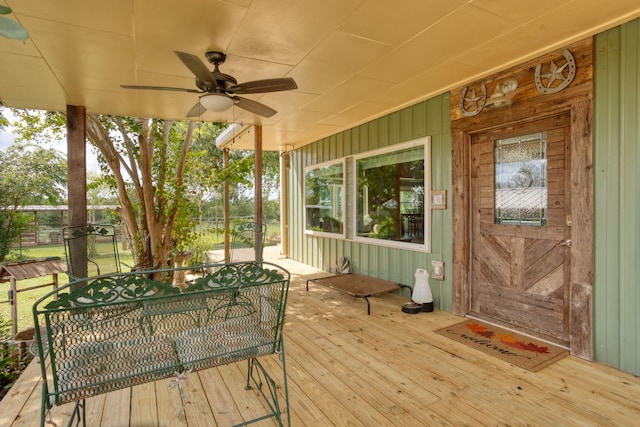 wooden terrace featuring ceiling fan and outdoor dining space