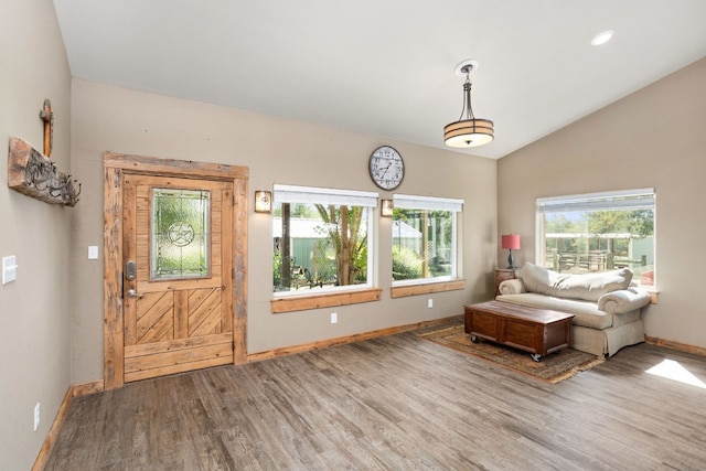 entryway with light wood-style floors, recessed lighting, vaulted ceiling, and baseboards