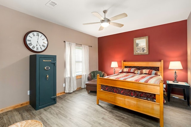 bedroom with ceiling fan and hardwood / wood-style flooring